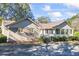 Ranch-style home exterior, showcasing landscaping and driveway at 3520 Tom Brewer Rd, Loganville, GA 30052