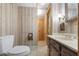 View of a vintage-style bathroom with wood-paneled walls and a double sink vanity at 3520 Tom Brewer Rd, Loganville, GA 30052