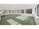 Sunroom features a vaulted ceiling, multiple windows, and green carpet at 3520 Tom Brewer Rd, Loganville, GA 30052