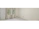 Bright bedroom with carpet flooring and two windows offering a view of nature at 3520 Tom Brewer Rd, Loganville, GA 30052