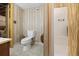 Basement bathroom with toilet, shower, and wood-paneled walls at 3520 Tom Brewer Rd, Loganville, GA 30052