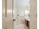 Vintage bathroom with floral wallpaper, wood vanity, and updated shower at 3520 Tom Brewer Rd, Loganville, GA 30052