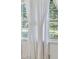 White curtains with tassels adorn large windows at 3520 Tom Brewer Rd, Loganville, GA 30052
