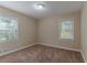Well-lit bedroom featuring carpet, neutral walls and two windows at 3289 Beech Dr, Decatur, GA 30032