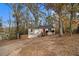 House nestled in wooded area with a long driveway at 3060 Wilkes Plantation Way, Douglasville, GA 30135