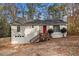 Ranch house with red door, wooden steps, and attached garage at 3060 Wilkes Plantation Way, Douglasville, GA 30135