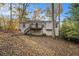 Ranch house exterior with deck and stairs, nestled in a wooded area at 3060 Wilkes Plantation Way, Douglasville, GA 30135