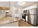 Modern kitchen featuring granite countertops and white cabinets at 3060 Wilkes Plantation Way, Douglasville, GA 30135