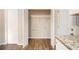 Laundry area with wood-look flooring and built-in shelving at 3060 Wilkes Plantation Way, Douglasville, GA 30135