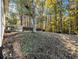 Wooded backyard with sloped terrain and partial fence at 3811 Paul St, Douglasville, GA 30135