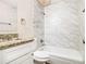 Updated bathroom with granite vanity and marble-tiled shower/tub at 3811 Paul St, Douglasville, GA 30135