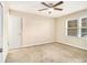 Carpeted bedroom with ceiling fan and large windows at 3811 Paul St, Douglasville, GA 30135