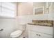 Updated bathroom with white tile, granite countertop, and white vanity at 4257 Midway Rd, Douglasville, GA 30134