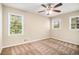 Bright bedroom with neutral walls, carpet, and multiple windows at 4257 Midway Rd, Douglasville, GA 30134