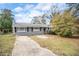 Ranch style home with gray exterior, landscaping, and a long driveway at 4257 Midway Rd, Douglasville, GA 30134