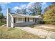 Gray ranch house with mature trees and a spacious driveway at 4257 Midway Rd, Douglasville, GA 30134