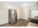 Stainless steel refrigerator in a kitchen with wood-look flooring at 4257 Midway Rd, Douglasville, GA 30134