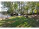 Large backyard with lush trees and a storage shed at 1396 Gale Dr, Norcross, GA 30093