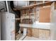 Unfinished basement area with water heater and ample storage at 1396 Gale Dr, Norcross, GA 30093