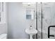 Modern bathroom with pedestal sink and marble shower at 1396 Gale Dr, Norcross, GA 30093