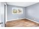 Bedroom with gray walls, wood-look flooring and large window at 1396 Gale Dr, Norcross, GA 30093