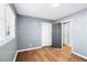 Bedroom with gray walls, wood-look flooring, and access to other rooms at 1396 Gale Dr, Norcross, GA 30093