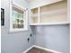 Laundry area with built-in shelving and space for a washer and dryer at 1396 Gale Dr, Norcross, GA 30093