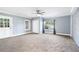 Spacious living room with neutral carpeting, fresh paint, and a ceiling fan at 1396 Gale Dr, Norcross, GA 30093