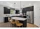 Modern kitchen featuring a large island, stainless steel appliances, and dark cabinetry at 5210 Sierra Creek Dr, Hoschton, GA 30548