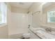 Clean bathroom with granite vanity, tub, and window at 3464 Linecrest Rd, Ellenwood, GA 30294