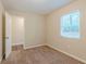 Bright bedroom with carpet, spacious closet, and a window with deck view at 3464 Linecrest Rd, Ellenwood, GA 30294