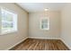 Bright bedroom with neutral walls, hardwood floors, and a window with blinds at 3464 Linecrest Rd, Ellenwood, GA 30294