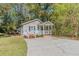 Newly built house with a large yard and a paved driveway at 3464 Linecrest Rd, Ellenwood, GA 30294