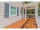 Inviting front porch with white railings and an orange-stained deck at 3464 Linecrest Rd, Ellenwood, GA 30294