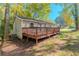 Rear view of house showing deck, yard, and wooded area at 3464 Linecrest Rd, Ellenwood, GA 30294