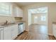 Modern kitchen features granite countertops, white cabinets, and stainless steel appliances at 3464 Linecrest Rd, Ellenwood, GA 30294