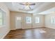 Spacious living room with wood-look flooring and a ceiling fan at 3464 Linecrest Rd, Ellenwood, GA 30294