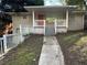 Brick ranch home with covered porch, steps, and a white picket fence at 214 Thornton Sw St, Atlanta, GA 30315