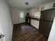 Eat-in kitchen with white cabinets, stainless steel appliances, and wood-look flooring at 214 Thornton Sw St, Atlanta, GA 30315
