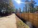 Long driveway with wooden fence and trees along the side at 5343 Highway 5, Douglasville, GA 30135