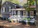 Gray house with white porch, two car garage, and landscaping at 5343 Highway 5, Douglasville, GA 30135