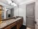 Basement bathroom with granite countertop and a gray door at 3616 Bogan Springs Dr, Buford, GA 30519