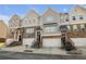 Three-story townhouses with attached garages and stairs at 4262 Buford Valley Way, Buford, GA 30518