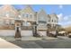 Three-story townhouses with attached garages and stairs at 4262 Buford Valley Way, Buford, GA 30518