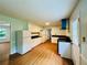 Open concept kitchen with white cabinets and wood flooring at 2636 Whippoorwill Cir, Duluth, GA 30097