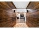 Basement hallway with dark wood walls and brick accent wall at 61 Alden Nw Ave, Atlanta, GA 30309