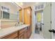Bathroom with light wood cabinets, a large mirror, and a toilet at 61 Alden Nw Ave, Atlanta, GA 30309