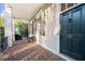 Inviting front porch with brick flooring and a dark green door at 61 Alden Nw Ave, Atlanta, GA 30309