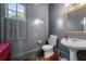 Powder room with gray walls, white pedestal sink, and wood floors at 61 Alden Nw Ave, Atlanta, GA 30309
