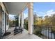 Spacious porch with wooden chairs and view of tree-lined street at 61 Alden Nw Ave, Atlanta, GA 30309